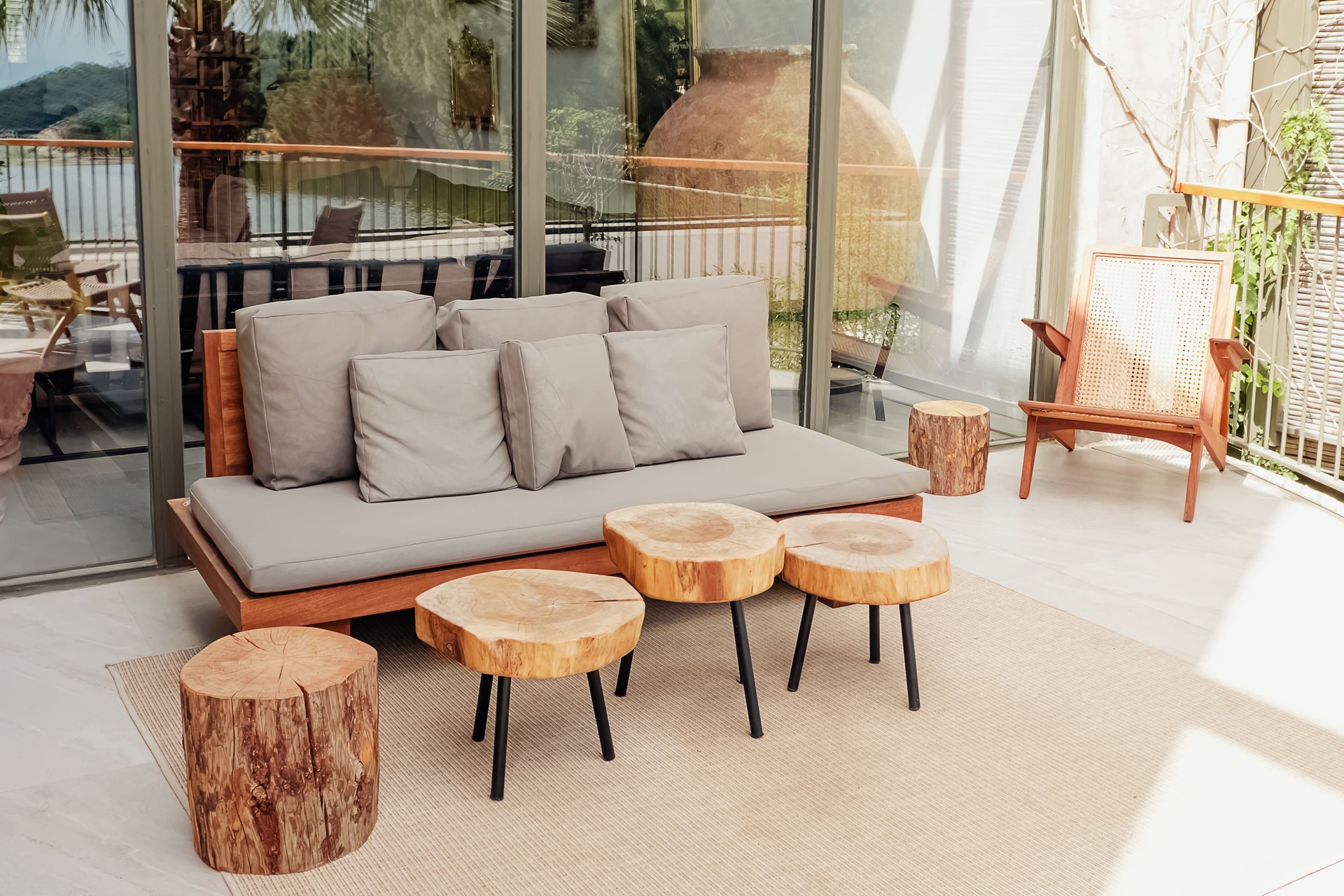 Wooden sofa and coffee tables on stylish modern terrace